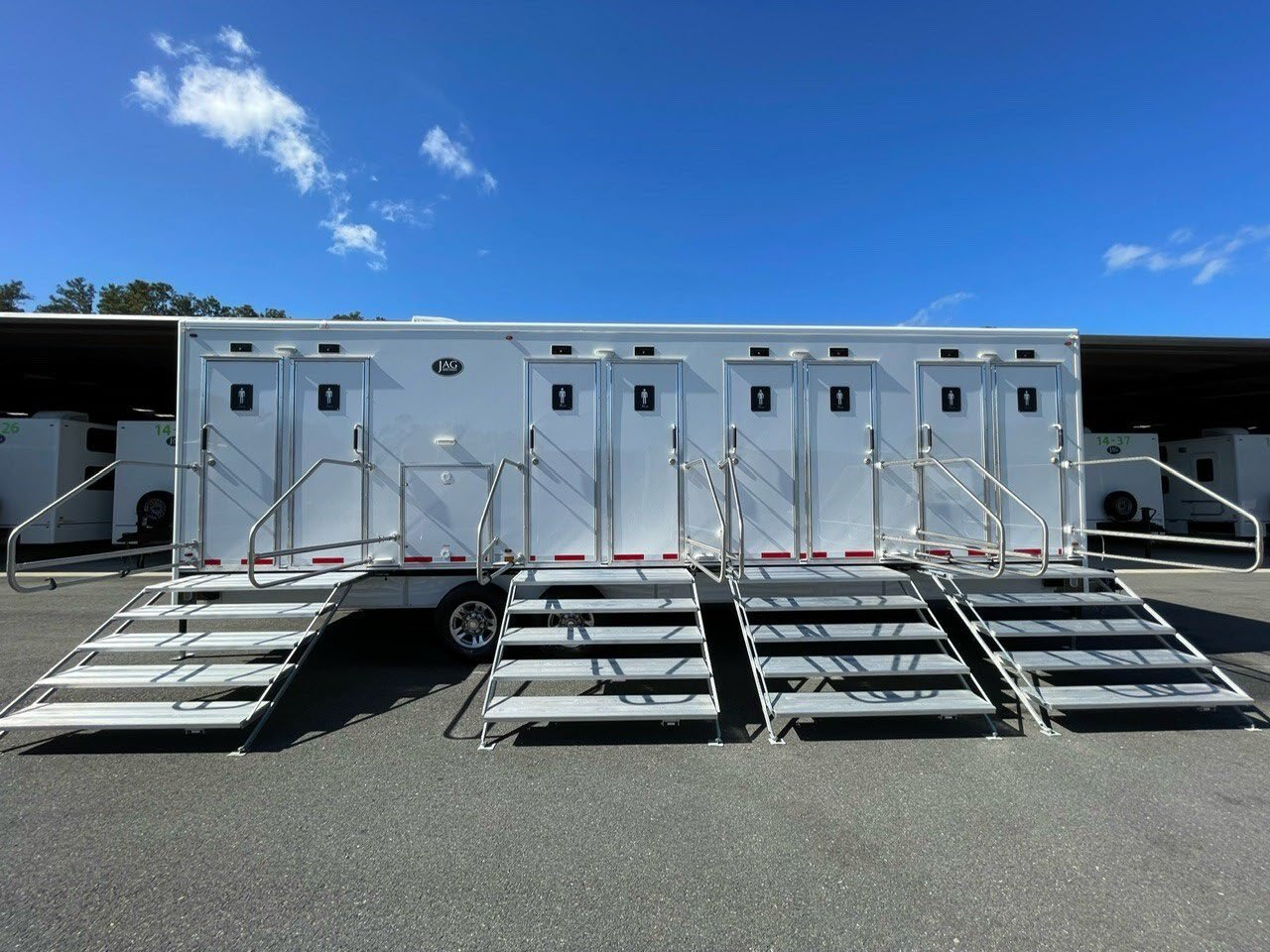Restroom and shower trailers staged for site sanitation support.